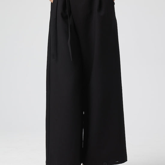 Model wears Black Pants