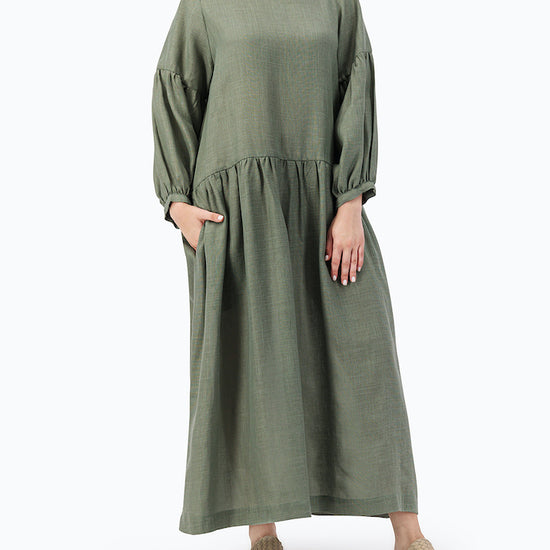 MODEL IS WEARING GREEN LOOSE DRESS- PROJECT 11.1