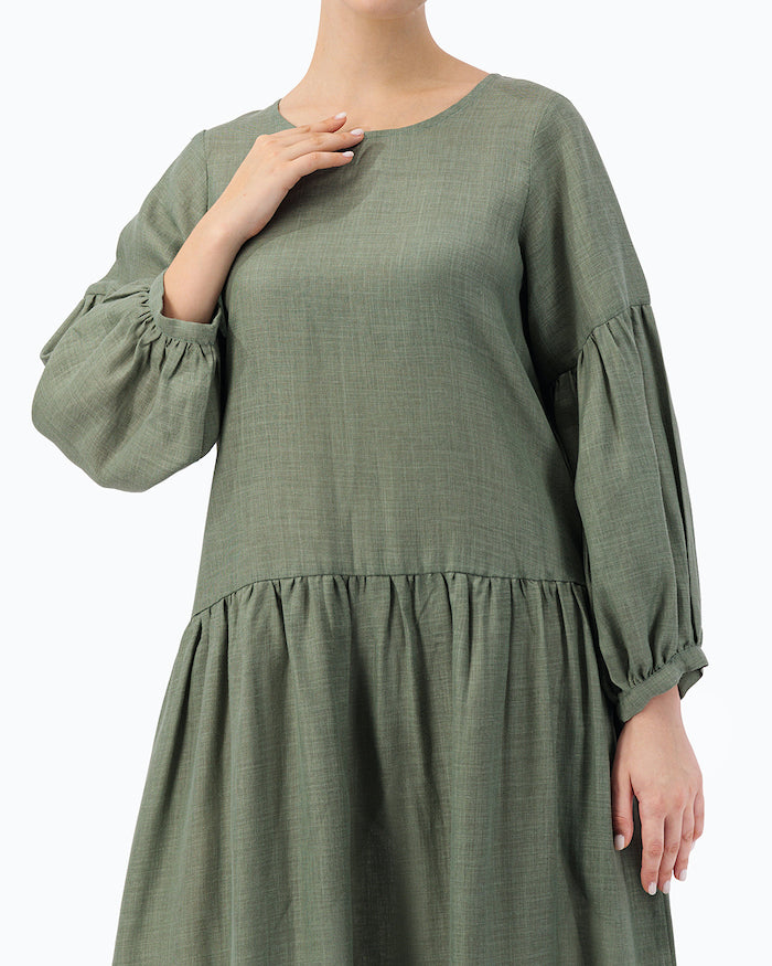 MODEL IS WEARING GREEN LOOSE DRESS- PROJECT 11.1