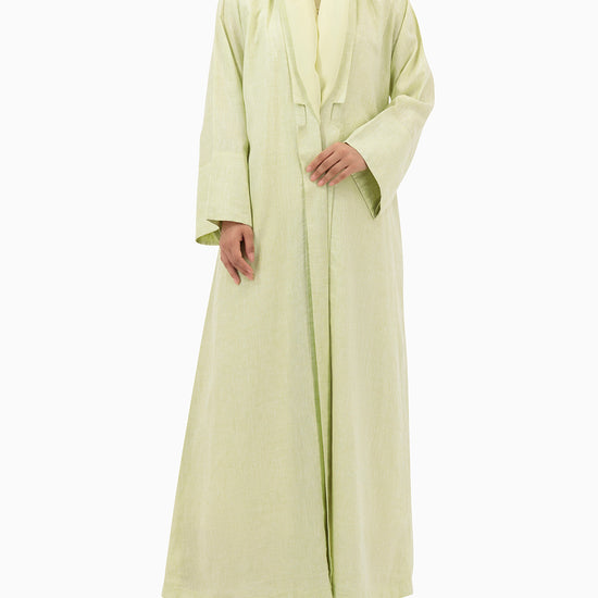 Model wears Pastel Green Linen Abaya